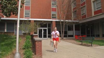 U of L campus dorm student walking
