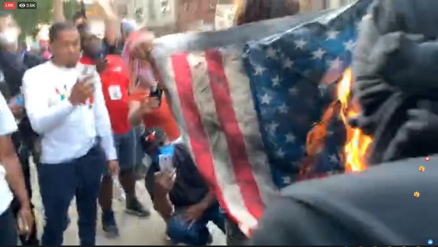 Protesters in downtown Louisville burn American flag