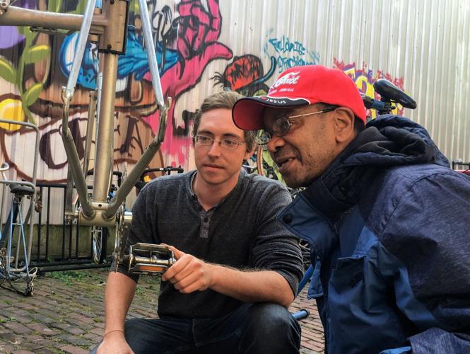 Nathan Green helps someone at Falls City Community Bikeworks