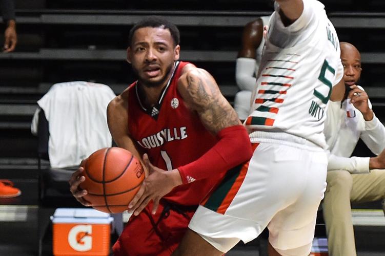 Louisville's Carlik Jones dribbles around a Miami defender