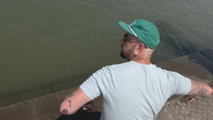 Stone Skipping Champ Jon Jennings prepares to toss a rock in the Ohio River