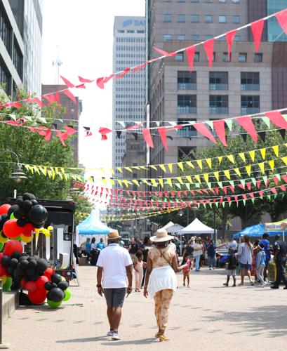 Couple walks at Juneteenth Festival.JPG