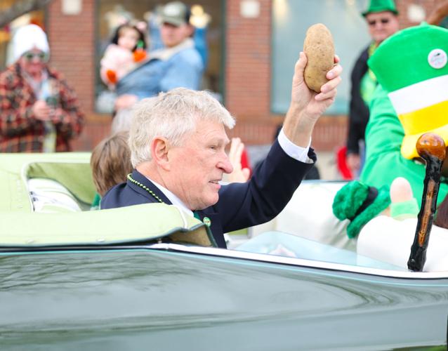 Man holds up potato at St. Patrick's Day Parade.JPG