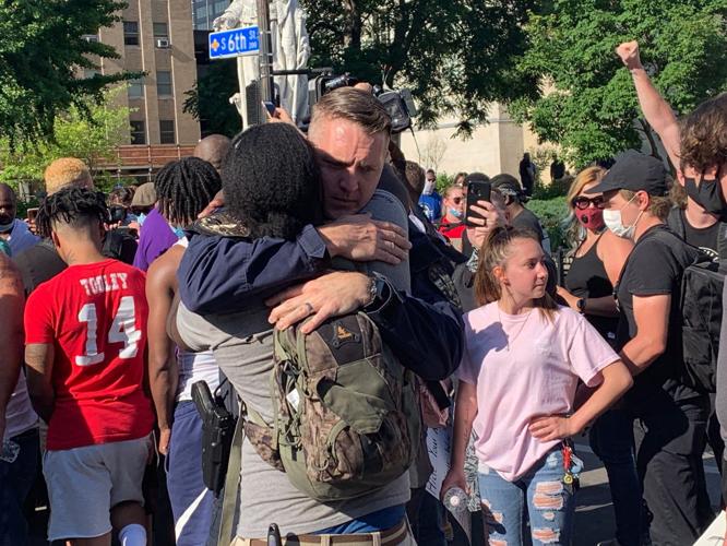 LMPD officer hugs protester-6-1-20.JPG