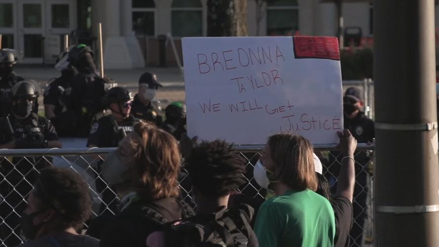 Sign during protesters outside Churchill Downs for Derby