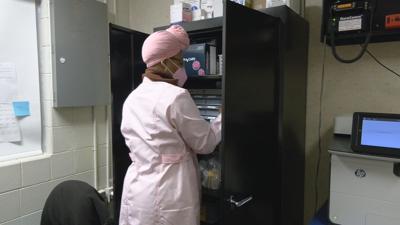 School nurse looking through medicine cabinet  1-26-22