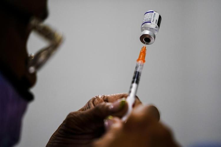 A syringe is prepared with the Pfizer COVID-19 vaccine.jpeg