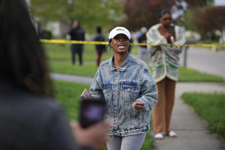 Shanise Washington talks to the crowd that had gathered with her anger at police response following a fatal police shooting