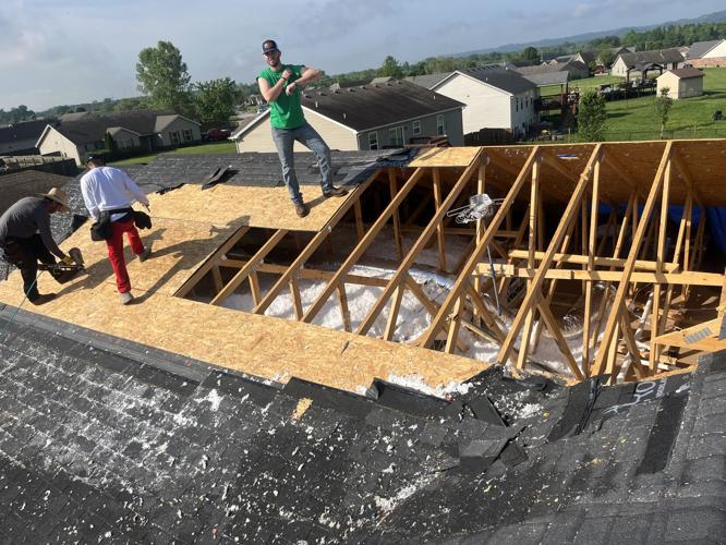 Workers repair tornado damaged roof in Sellersburg