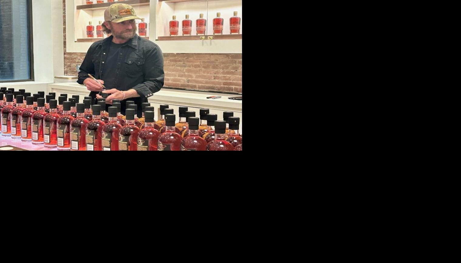 Dierks Bentley with bottles to sign.jpg