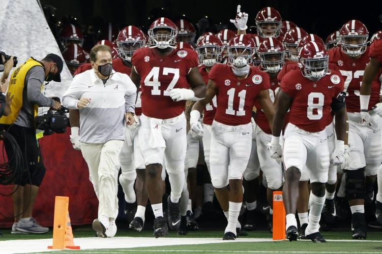 Alabama head coach Nick Saban, front left, jogs onto the field with his team for their Rose Bowl