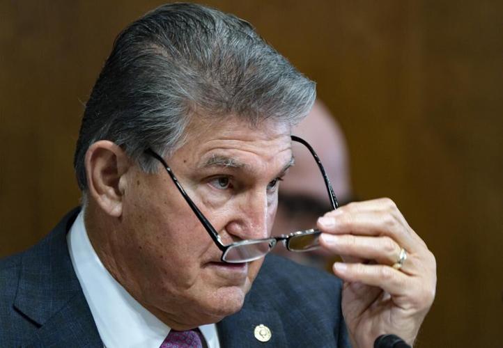 Manchin adjusts glasses