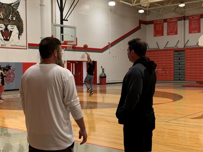 Atherton player shoots baskets as coaches watch