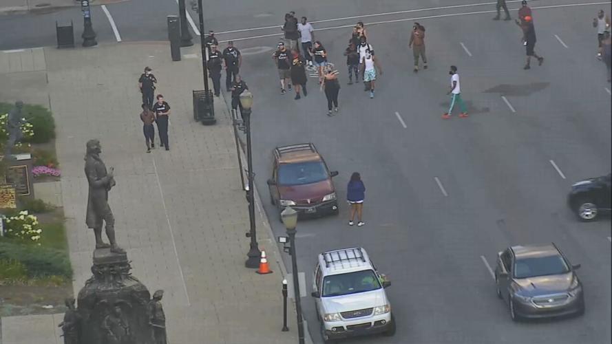 Police lead man in custody down Jefferson Street after firing shot in air