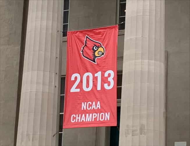 Banner hung at Louisville's Metro Hall to honor 2013 U of L men's basketball team as NCAA Champs