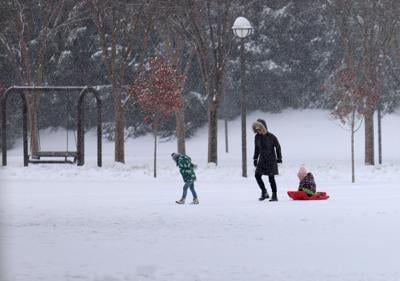 Three people walk in snow at Waterfront Park - Jan. 10, 2025.JPG