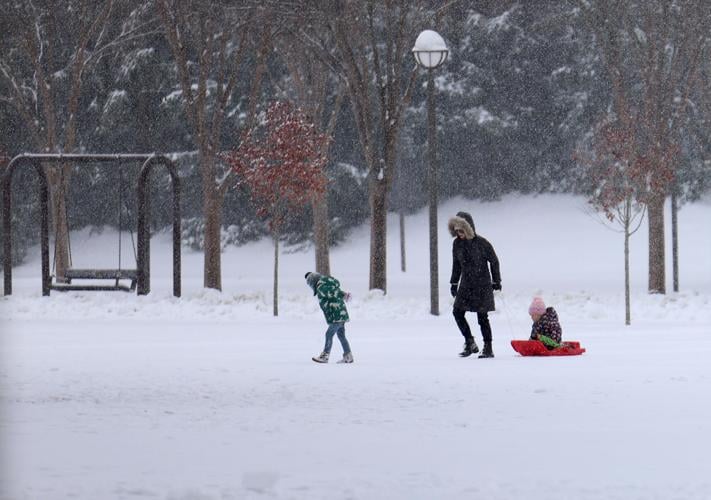 Three people walk in snow at Waterfront Park - Jan. 10, 2025.JPG