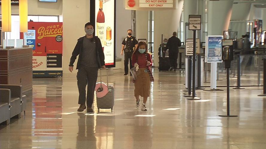 Travelers walk through the Louisville Muhammad Ali International Airport