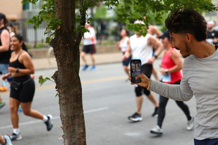 Person follows runners with video.JPG