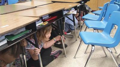 Drop, cover and hold on! Louisville students participate in earthquake drill