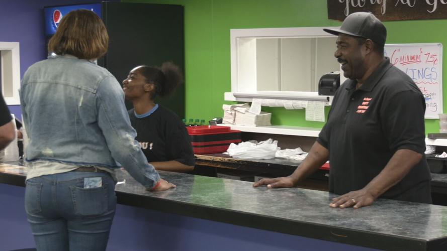 Barry Washington, owner of Louisville-based Barry's Cheesesteaks, speaks with a customer