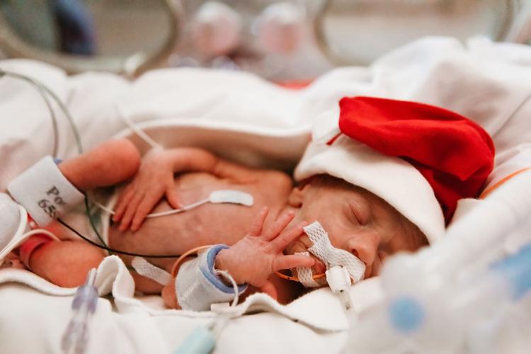 NICU baby in Santa hat at Baptist Health Louisville