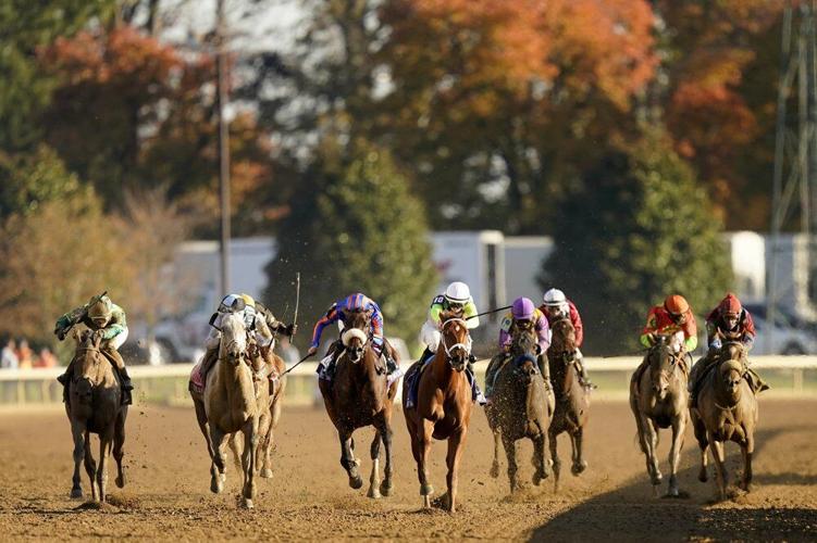 Florent Geroux (10) rides Monomoy Girl to win the Breeders' Cup Distaff horse race at Keeneland Race Course