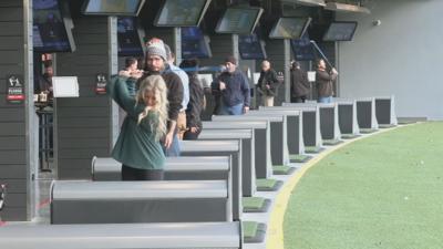 Customer swings at Topgolf Louisville at Oxmoor Center in St. Matthews