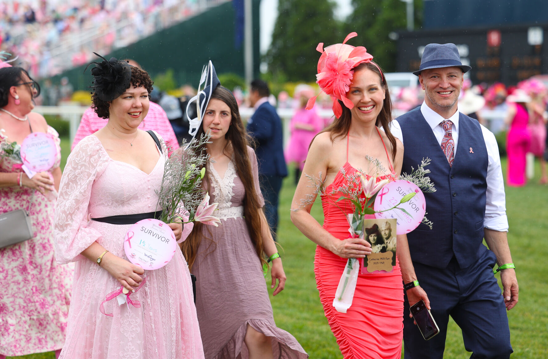 Survivors smile for photos during parade.JPG