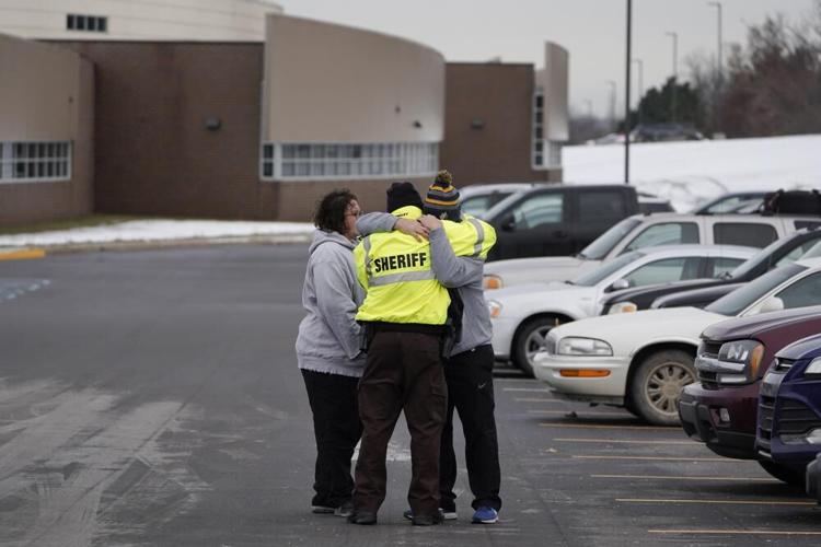 Sheriff's deputy hugs family after Michigan school shooting