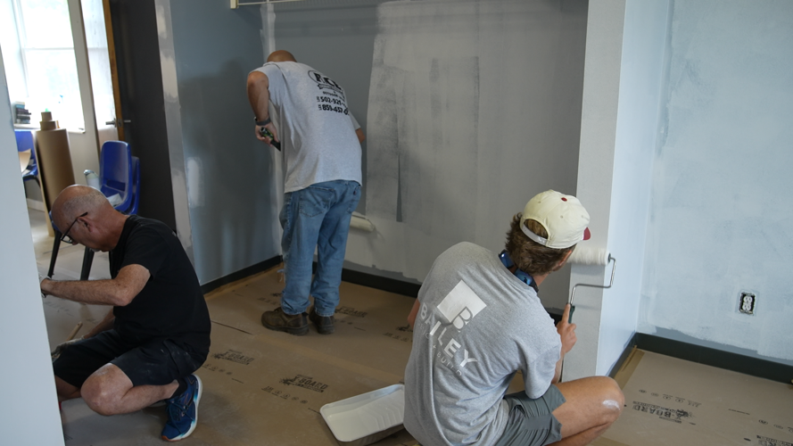 men painting a building