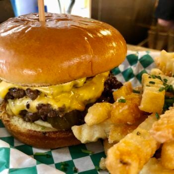The Double Smashburger on Brioche Bun with Tasty Pickles by Dallas McGarity of Louisville