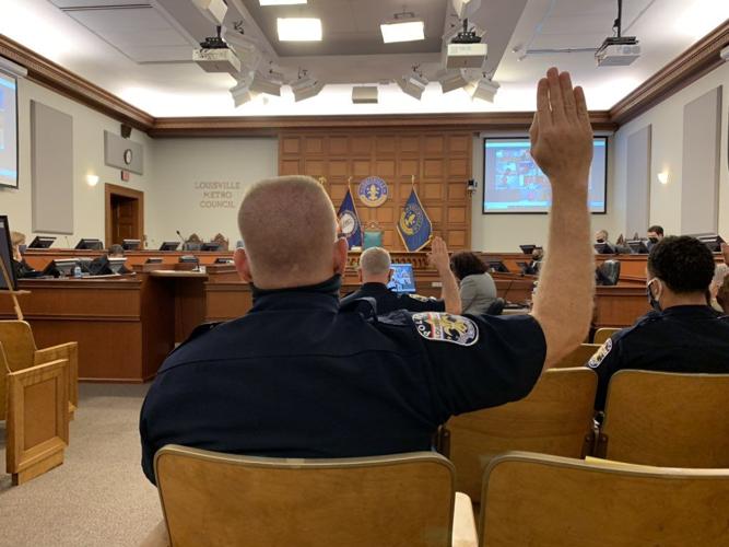 LMPD officers raise their right hands before testifying in front of a Metro Council committee