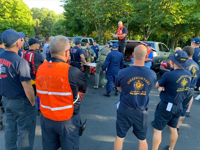 First Responders listen to safety instructions during a briefing before boat training