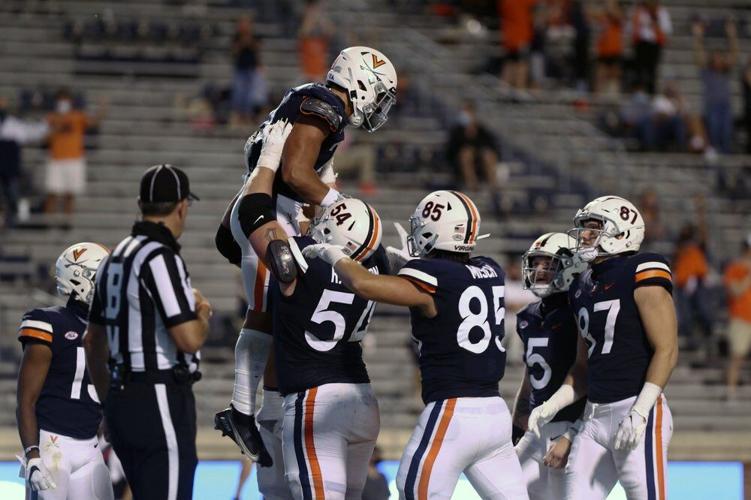Virginia players celebrate a score during an NCAA college football game