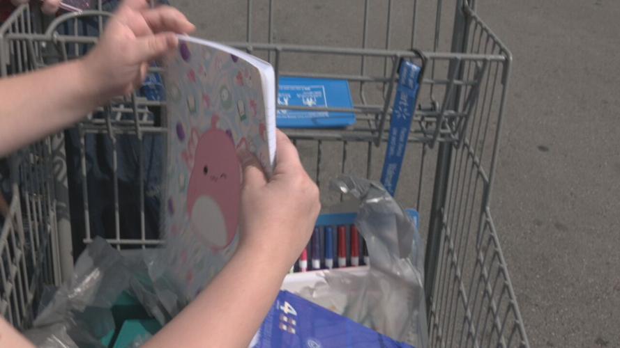 Back to school supplies  - student holds notebook