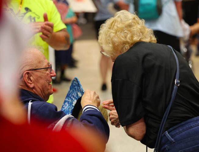 Couple embraces during Honor Flight Return Home.JPG