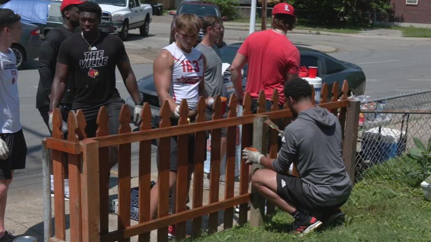 University of Louisville football players help repair a home in the Portland neighborhood