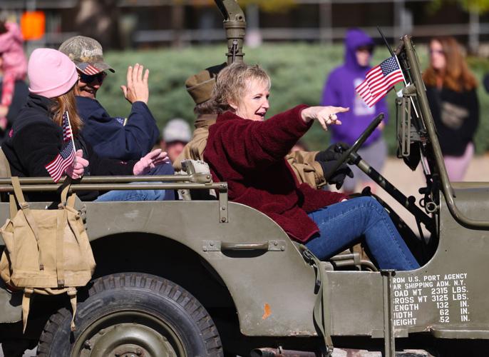 Woman points to crowd at parade.JPG