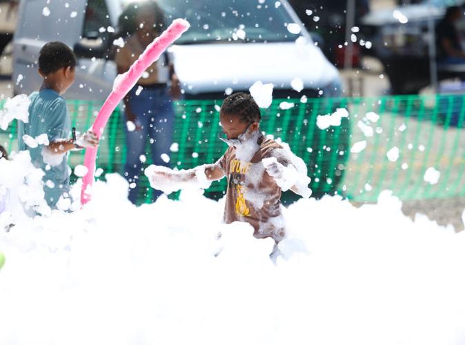 Child plays in foam at Louisville Juneteenth Festival.JPG