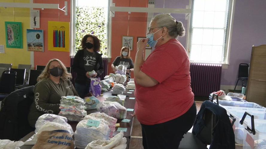 Volunteers assemble food bags, hygiene kits at La Casita Center 4-7-23