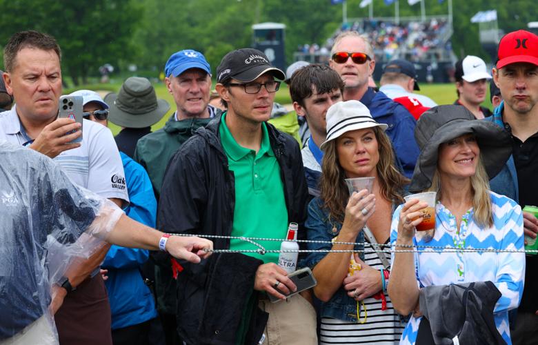 People wait for golfers to pass.JPG