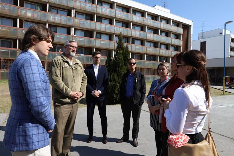 Holcomb with  Ukrainian refugees.jpeg