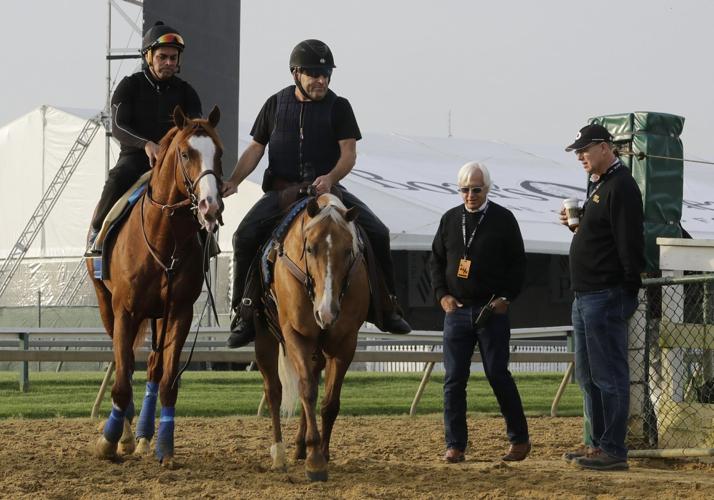 Improbable is lead back to the barn with trainer Bob Baffert