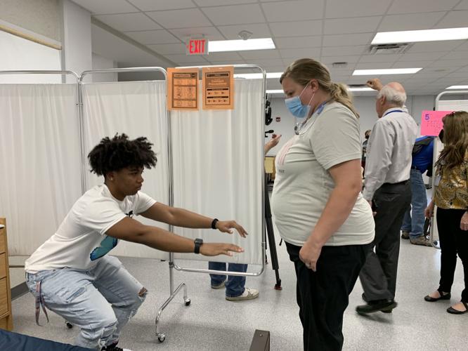 A JCPS student gets a free physical at Moore High School on July 11, 2022