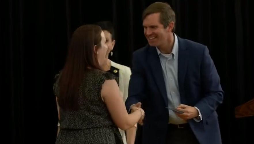 Beshear shakes hands with winner of educator award