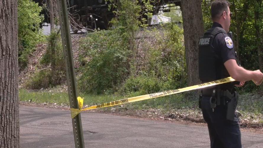 LMPD officer with crime scene tape after fatal shooting in Crescent Hill
