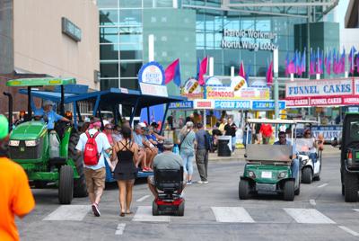 People walk around outside at state fair.JPG
