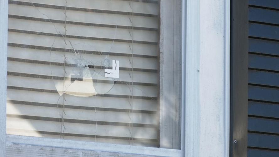 Bullet holes in window of home on Sale Avenue. (WDRB photo)