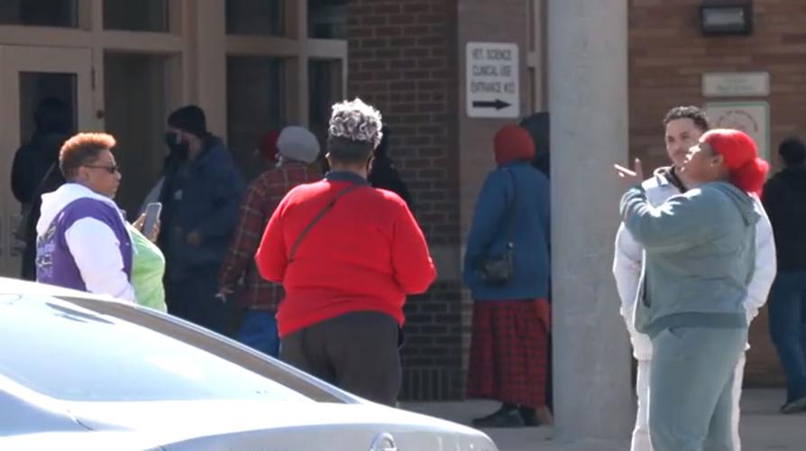 Parents wait outside Central High School during student protests on March 9, 2022